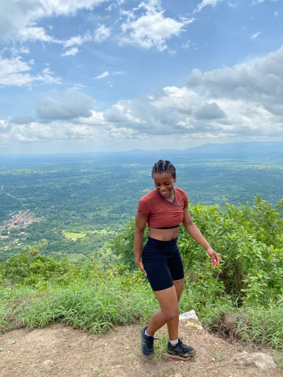 Hiker at the summit of Mount Afadjato with panoramic views