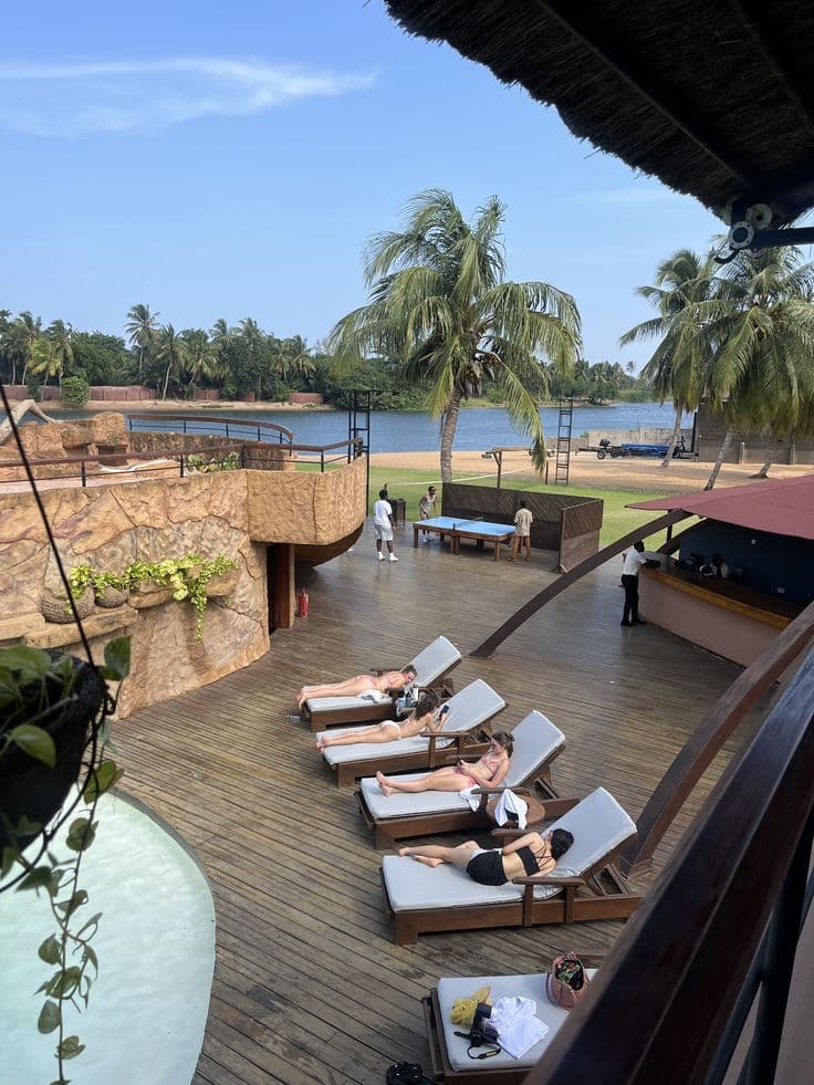 Resort with pool and palm trees at Ada Foah