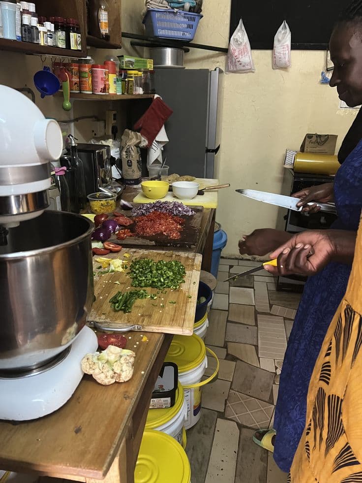 Person chopping vegetables in a traditional kitchen