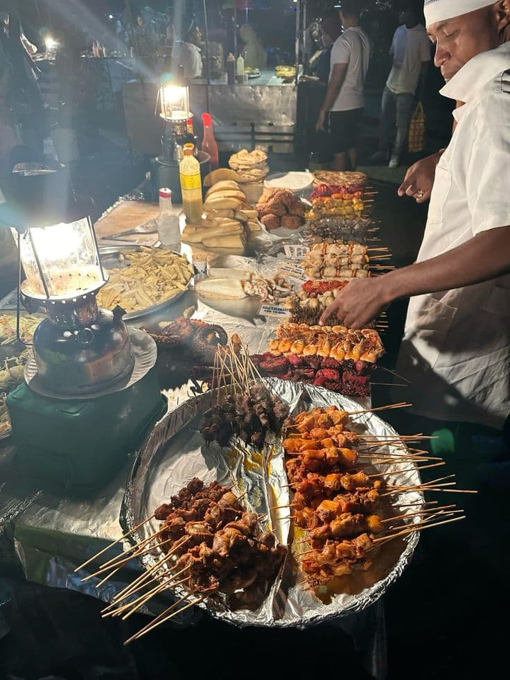 Night market vendor with traditional dishes